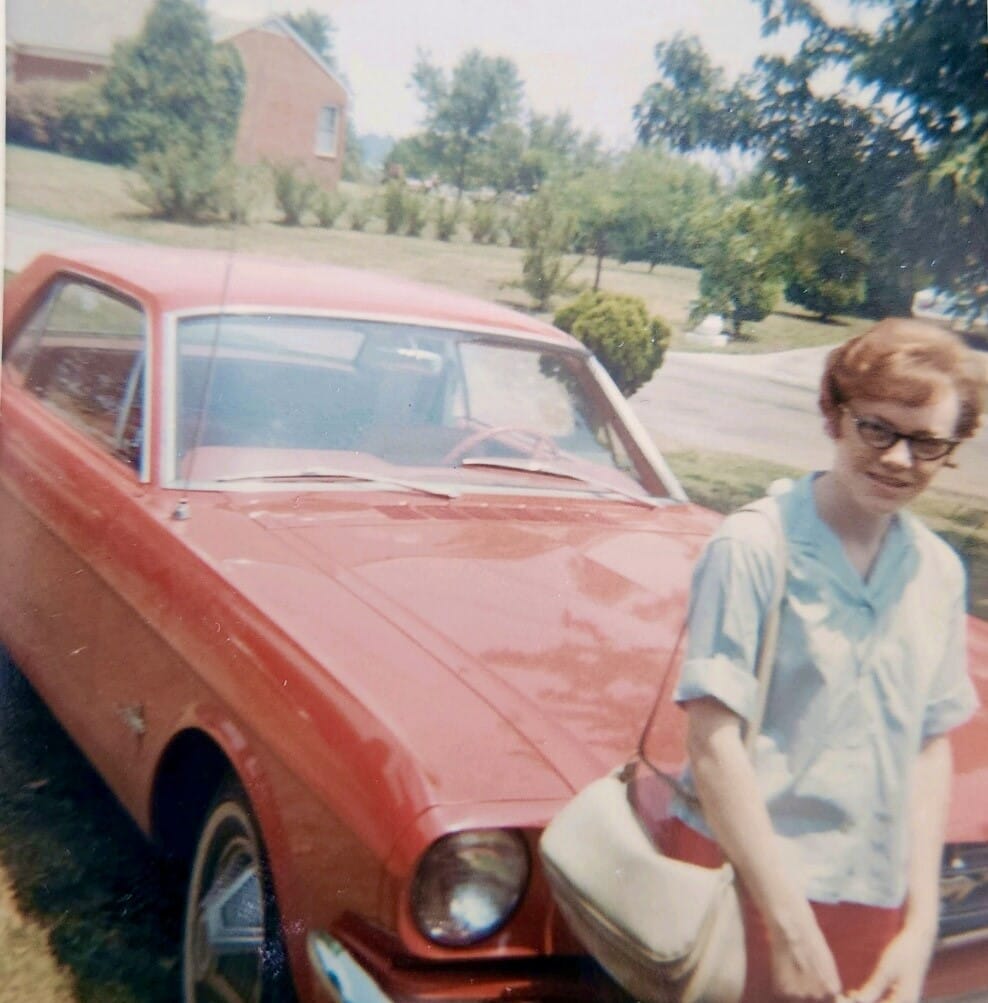 photo of Carolyn with her favorite red Mustang