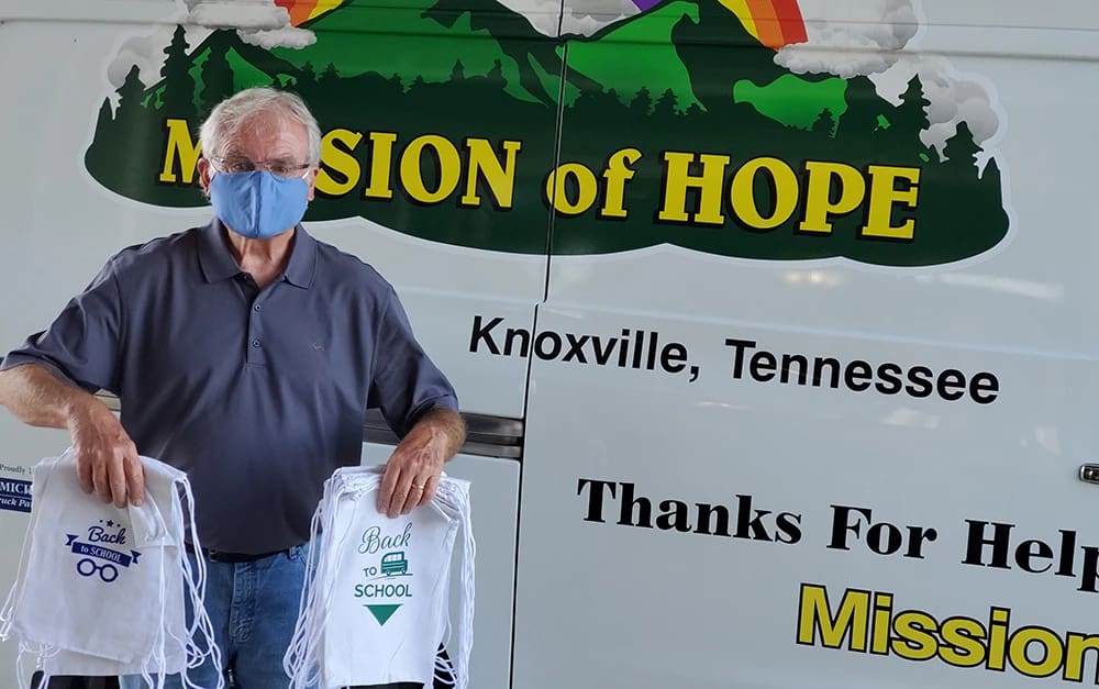 Senior man posing in front of Mission of Hope van