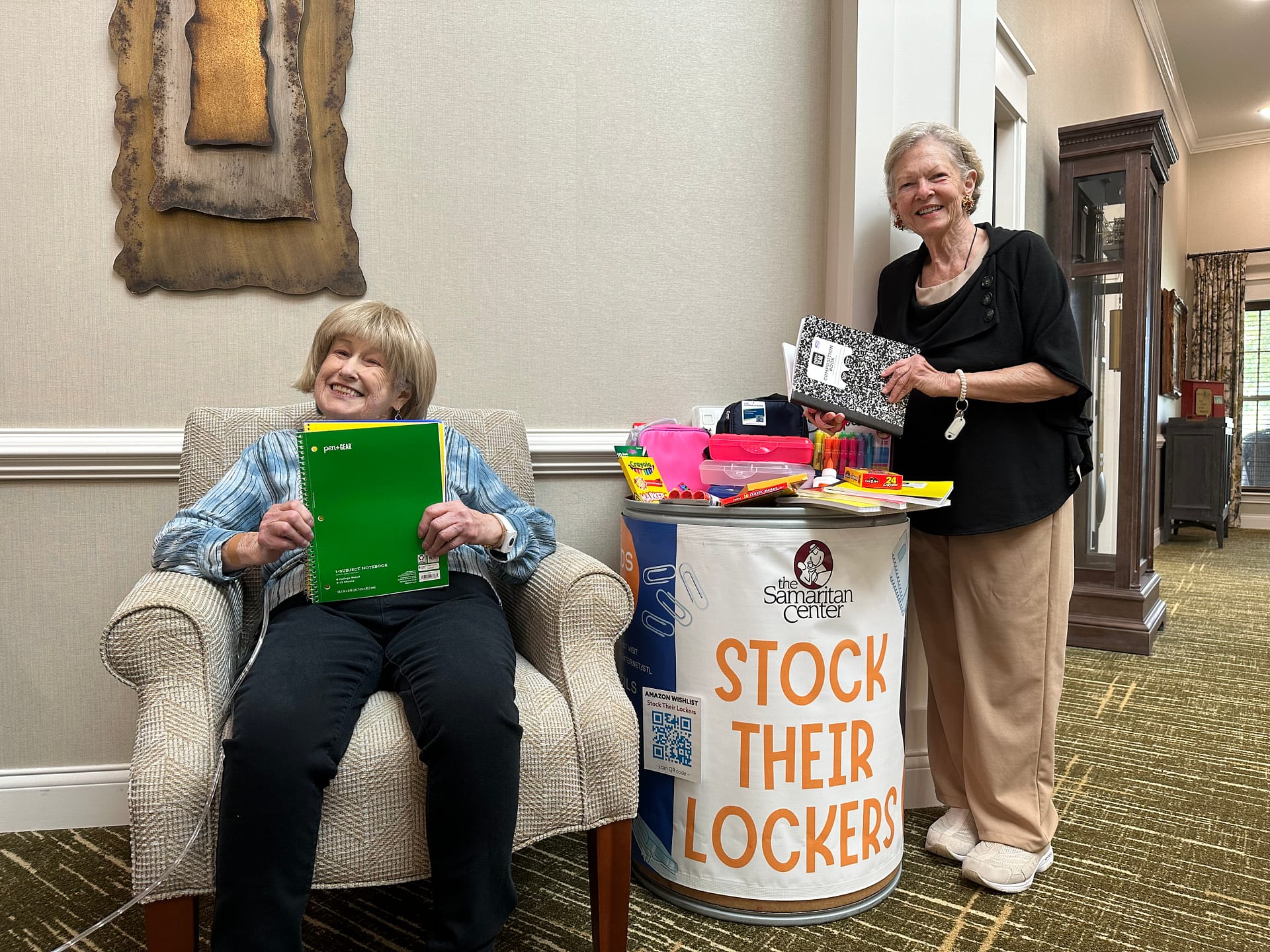 Morning Pointe of Chattanooga residents Erika Brouner (seated) and Donna Stetler (standing), with the Stock Their Lockers barrel