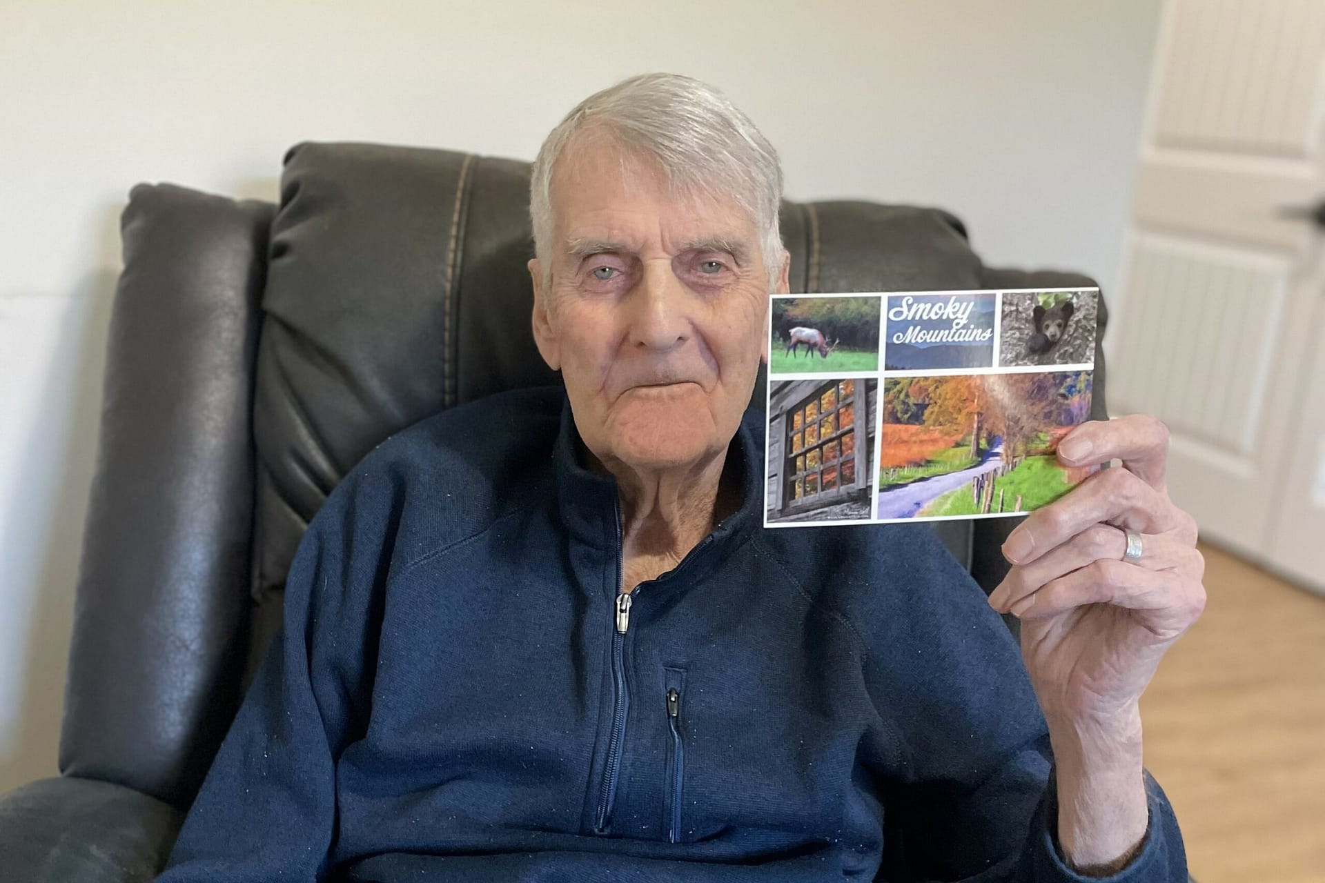 photo of Powell Lantern resident with a postcard from Dennis