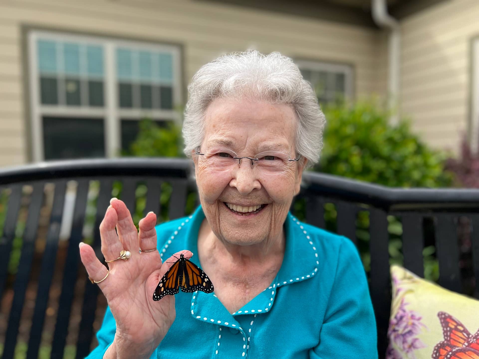 photo of released monarch with resident Eileen Beattie