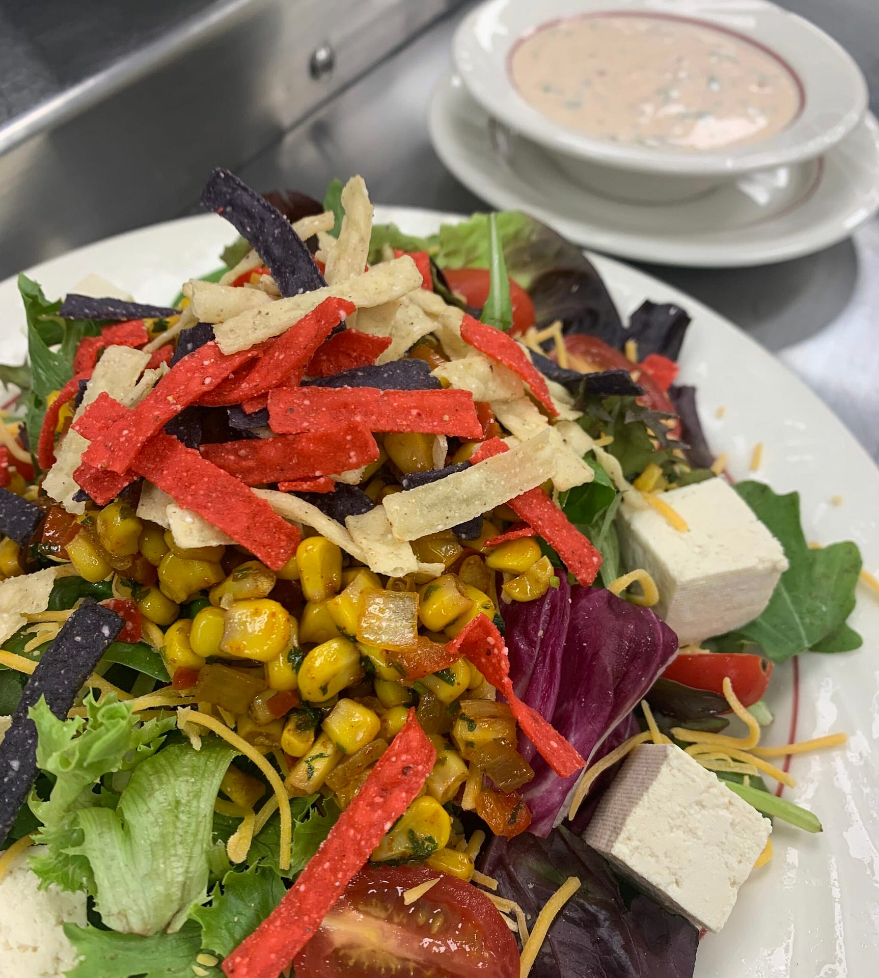 Salad with lettuce, corn, tortilla strips, and other vegetables at senior living community
