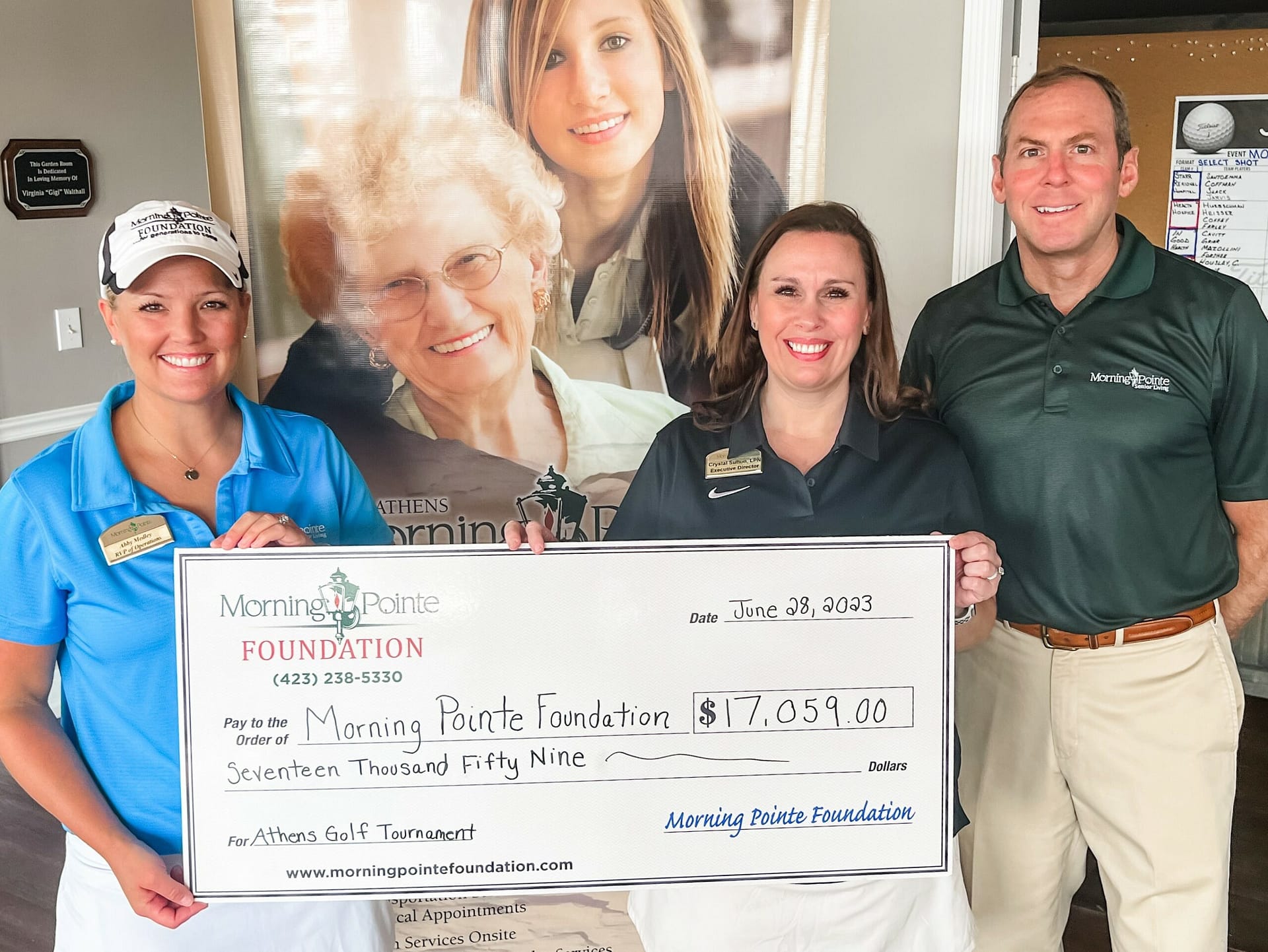 Photo of fundraising check for the Athens Golf Tournament